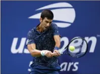  ?? The Associated Press ?? DECISION TIME: Novak Djokovic, of Serbia, returns a shot to Juan Martin del Potro, of Argentina, during the men’s final of the U.S. Open in New York on Sept. 9, 2018. Djokovic is fretting about “harsh” restrictio­ns on players’ entourages and other “extreme” changes proposed for the U.S. Open, if it is played starting in August.
