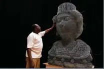  ?? (File Photo/AP/Alberto Pezzali) ?? Artist Carl Gabriel touches his sculpture made of wire depicting the head of Britain’s Queen Elizabeth II on June 1 ahead of the Platinum Jubilee weekend in London.