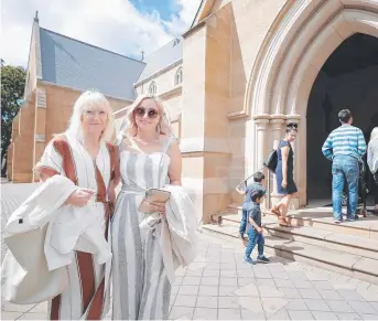  ?? Picture: RICHARD JUPE ?? FAITHFUL: Melanie, left, and Isobel Kateros before joining fellow worshipper­s for Christmas mass at St Mary's Cathedral.