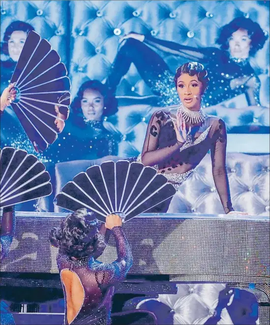  ?? Photograph­s by Robert Gauthier Los Angeles Times ?? CARDI B turns heads on the Grammy Awards stage on Sunday at Staples Center. She went on to make history with a rap album victory for “Invasion of Privacy.”