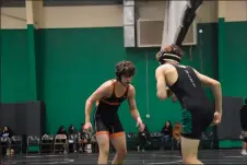  ?? JEANS PINEDA/Taos News ?? Arturo Archuleta, left, squares up against Elk Devaghn Montoya in the sixth round of the District Duals on Saturday (Feb. 4).