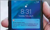  ?? ASSOCIATED PRESS ?? IN THIS PHOTO TAKEN THURSDAY, JEREMY DAROS shows the erroneous tsunami alert he received on his phone on Tuesday in Portland, Maine. DeRos, who lives near the water, said he is concerned that people won’t take seriously the emergency alerts they get in an actual crisis.