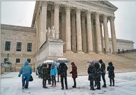  ?? J. SCOTT APPLEWHITE/AP ?? Visitors wait to enter the Supreme Court amid a winter storm that blanketed the nation’s capital Wednesday.