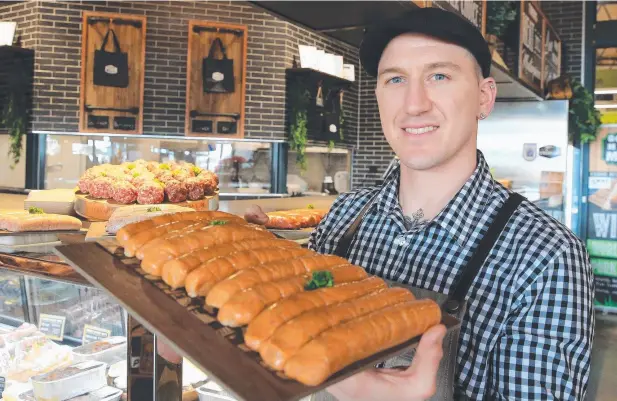  ??  ?? NEW RECIPES: Nick Dagg, owner of Gourmet Market Meats, is ready for the big NQ Sausage King competitio­n tomorrow. Picture: JUSTIN BRIERTY