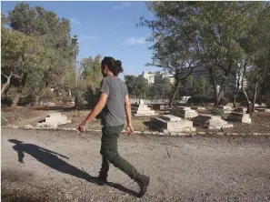  ?? (Marc Israel Sellem/The Jerusalem Post) ?? A MAN WALKS through the Mamilla cemetery in downtown Jerusalem yesterday.