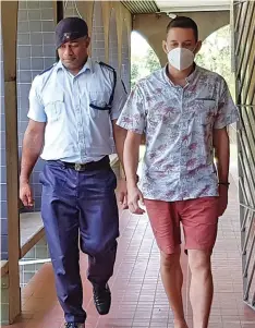  ?? Nicolette Chambers ?? Bradley Robert Dawson escorted by a Police officer at the High Court in Lautoka on January 20, 2023. Photo: