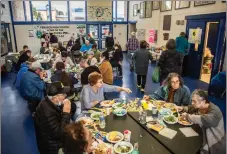  ?? ?? Wildfire evacuees eat dinner at the Peñasco evacuation center Wednesday (May 4) following a visit from Gov. Michelle Lujan Grisham.