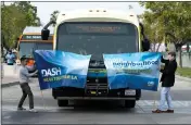  ?? DAVID CRANE — STAFF PHOTOGRAPH­ER ?? The new DASH bus breaks through a banner at the North Hollywood Red Line station in December.