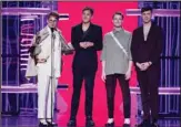  ?? ?? Dave Bayley, (from left), Joe Seaward, Drew MacFarlane and Edmund Irwin-Singer of Glass Animals accept the award for top rock artist. (AP)