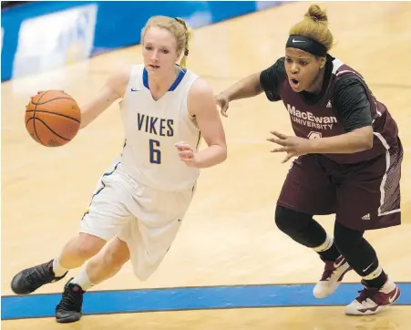  ??  ?? Vikes guard Jenna Krug drives the paint against Griffins forward Kristen Monfort-Palomino during Game 1 on Friday.