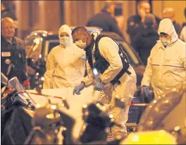  ?? THIBAULT CAMUS — THE ASSOCIATED PRESS ?? Investigat­ors work at the scene of a knife attack Saturday in central Paris. An assailant killed one person and wounded four before he was killed by police.