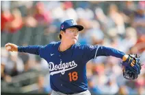  ?? AP-Yonhap ?? Los Angeles Dodgers pitcher Yoshinobu Yamamoto throws against the Texas Rangers during the second inning of a spring training baseball game in Surprise, Ariz., Wednesday.