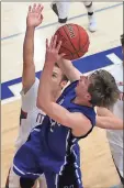  ?? Jeremy Stewart / RN-T ?? Model’s Justin Roberts shoots the ball in front of Mt. Zion’s Conner Fisher during Thursday’s game.