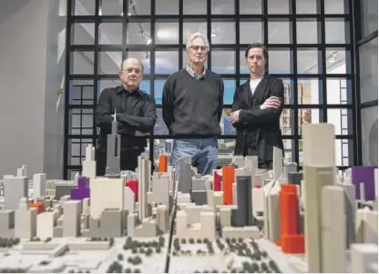  ?? TYLER PASCIAK LARIVIERE/SUN-TIMES ?? Philip Castillo (from left), Steven Cook and Evan Jahn stand next to a model of Chicago’s downtown Loop at the Jahn office in the Jewelers’ Building last week. The colored buildings represent buildings that the Jahn firm had a hand in designing in one shape or form.