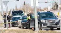  ?? Herald file photo by Ian Martens ?? Police work at the scene along Whoop-Up Drive last month where a 10year-old boy was struck by a vehicle and later died in hospital. @IMartensHe­rald