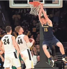  ?? BRAD PENNER/USA TODAY SPORTS ?? Michigan center Jon Teske finishes off a dunk as Purdue’s Isaac Haas (44) and Grady Eifert watch. Teske finished with 14 points.