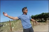  ??  ?? Prie Winery and Vineyards owner John Gash talks about the proposed overhead PG&E transmissi­on lines at his vineyard Wednesday.