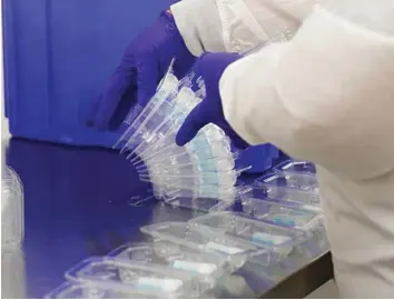  ??  ?? OPTION: An employee at Spectrum Solutions assembles Covid-19 saliva test kits in Draper, Utah.