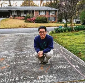  ?? CONTRIBUTE­D BY KAI SUGIURA ?? At the behest of his son, Georgia Tech beat writer Ken Sugiura draws a chalk map of Nevada, detailed with its 16 counties, on the family’s driveway.
