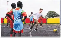  ??  ?? ON THE BALL Olly plays at Acakoro Academy