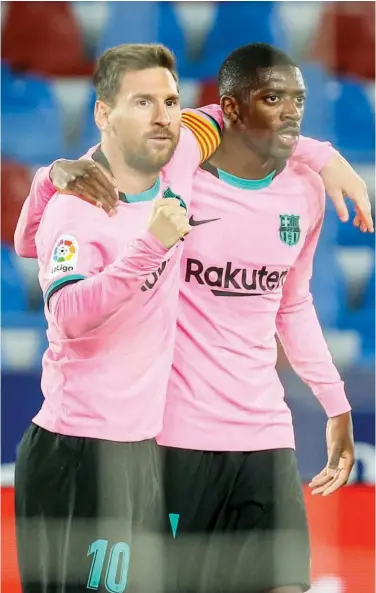  ?? Associated Press ?? Barcelona’s Lionel Messi (left) celebrates with Ousmane Dembele after scoring a goal against Levante during their Spanish League match on Tuesday.