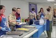  ?? Kevin Myrick ?? Top: A good crowd kept the Goodyear Civic Center filled on Saturday morning for Ham and Egg Day 2019. The annual breakfast serves as a fundraiser for the Cedartown Optimist Chub annually. Above: Boy Scouts from Troop 21 helped on the serving line for Ham and Egg Day 2019./