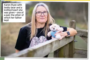  ??  ?? Karen Ryan with teddy bear and a knitted heart she was given – one of a pair, the other of which her father kept