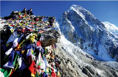  ?? Credit: Gerard Dunne ?? Middle: Kala Patthar Summit with Prayer Flags - The trekkers climbed the Kala Patthar Summit to enjoy the best closeup view of Everest.