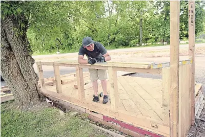  ?? DAVID BEBEE WATERLOO REGION RECORD ?? Wooden Boat Food Company owner Thompson Tran is building a patio in anticipati­on of serving restaurant patrons under strict spacing restrictio­ns.