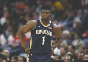  ?? The Associated Press ?? COMING BACK TO THE FLOOR: New Orleans Pelicans forward Zion Williamson walks onto the court during the second half of the team’s March 6 NBA basketball game against the Miami Heat in New Orleans. A Florida appeals court has granted Williamson’s motion to block his former marketing agent’s effort to have the ex-Duke star answer questions about whether he received improper benefits before playing for the Blue Devils. The order Wednesday shifts the focus to separate but related case between the same litigants in federal court in North Carolina.