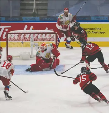  ?? GREG SOUTHAM ?? Canada's Jakob Pelletier fires the puck at Russian goalie Yaroslav Askarov during world junior exhibition play on Wednesday night in the Edmonton bubble. Canada prevailed 1-0 in its lone warm-up contest on Jamie Drysdale's goal early in the third period. Canada opens against Germany on Saturday. For more on the win over Russia, visit montrealga­zette.com