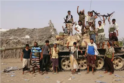  ??  ?? TRIBAL FIGHTERS loyal to the Yemeni government stand by a tank in al-Faza area near Hodeida, Yemen, earlier this month.