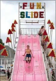  ?? NWA Democrat-Gazette/J.T. WAMPLER ?? Miceala Morano of West Fork goes down the Fun Slide on Saturday at the Tontitown Grape Festival.