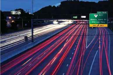  ?? STAFF PHOTOS BY ROBIN RUDD ?? The brake lights and headlights of traffic on Interstate 75 appear as streaks of light during a long exposure in 2017.