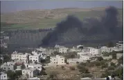  ?? NASSER NASSER — THE ASSOCIATED PRESS ?? Smoke fills the sky after Israeli settlers set fire to the properties of Palestinia­n villagers in the West Bank village of al-Mughayyir on Saturday.