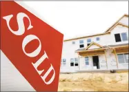  ?? Associated Press ?? A sold sign stands in front of a home under constructi­on in West Des Moines, Iowa.