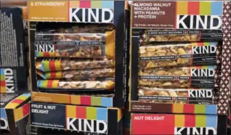  ?? ASSOCIATED PRESS FILE PHOTO ?? This file photo shows Kind snack bars on display at a supermarke­t in New York. The government’s definition of healthy came under scrutiny in late 2015, when the FDA warned Kind that its snack bars had too much fat to use the term. Kind pushed back, saying the fat came from nuts.