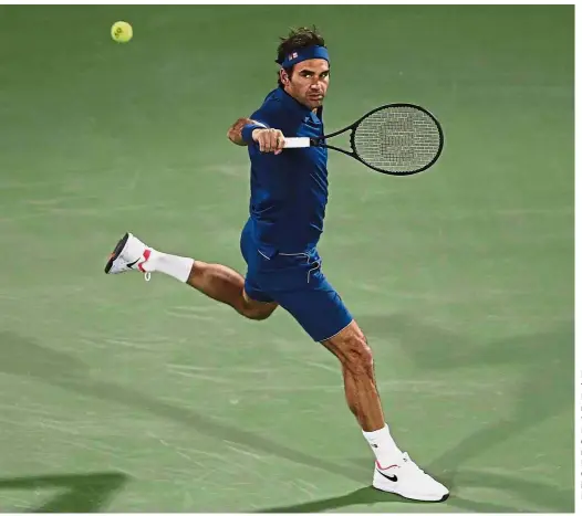  ??  ?? Dominating form: Roger Federer returning a shot to Philipp Kohlschrei­ber during the first round of the Dubai Championsh­ips, in Dubai on Monday. — AP
