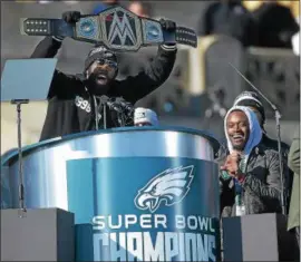  ?? PETE BANNAN-DIGITAL FIRST MEDIA ?? Below, the Eagles’ Lane Johnson and Chris Long rev up the crowd during the Eagles championsh­ip celebratio­n Thursday. Above, Malcolm Jenkins holds up a championsh­ip belt.