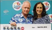  ?? CONTRIBUTE­D BY FLORIDA LOTTERY ?? David Floering (left) and his wife Mary collect $2 million in Powerball winnings.