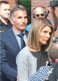  ??  ?? (Above and below) Loughlin and husband Giannulli exit the Boston Federal Court house after a pre-trial hearing at the John Joseph Moakley US Courthouse in Boston on Tuesday. — AFP photos