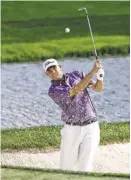  ?? AP ?? Bill Haas hits out of the bunker on the ninth hole during the second round of the Memorial on Friday in Dublin, Ohio. Haas was leading when play was suspended.