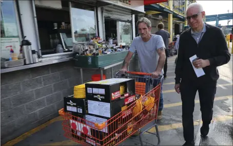  ?? JIM WILSON — THE NEW YORK TIMES ?? James Sampson, left, chief of facilities at UC Berkeley’s Space Sciences Laboratory, and Manfred Bester, director of the mission operations center, buy extension cords Tuesday at the Emeryville Home Depot for backup generators needed to monitor the launch of NASA’s ICON satellite.