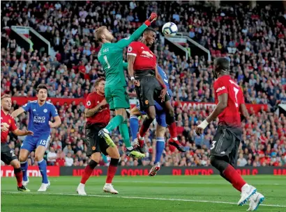  ?? Reuters ?? Manchester United’s goalkeeper David De Gea punches a shot away during the Premier League match against Leicester City. —