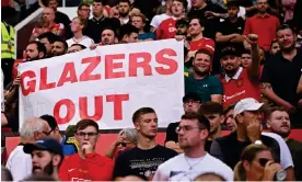  ?? Oli Scarff/AFP/Getty Images ?? Manchester United fans protest against the club’s owners earlier this season. Photograph: