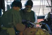  ?? FRANCOIS MORI — THE ASSOCIATED PRESS FILE ?? Medical workers tend to a patient affected with the COVID-19 in the Amiens Picardie hospital on March 30 in Amiens, north of Paris.