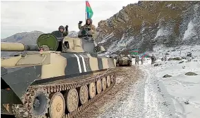  ?? AP ?? Azerbaijan soldiers sit atop their tank on a road in the Kalbajar region of Azerbaijan.