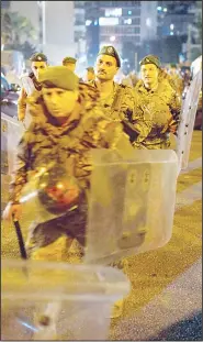  ?? (AP) ?? Lebanese security forces move into position outside the home of newly-assigned Lebanese Prime Minister, Hassan Diab, following his meeting with Lebanese President Michel Aoun in Beirut
on Dec 19.