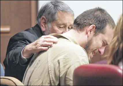  ?? HENRY TAYLOR PHOTOS / AJC ?? Attorney Jim Berry places his hand on the back of Jose Ismael Torres on Monday at the Douglas County Courthouse in Douglasvil­le. Torres received a sentence of 20 years.