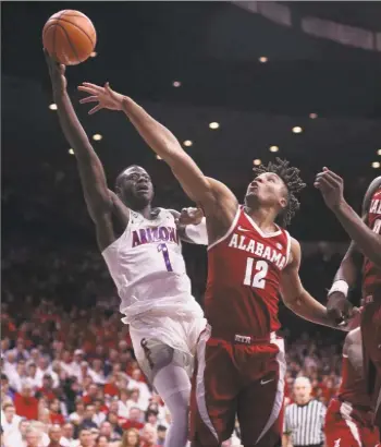  ?? Christian Petersen / Getty Images ?? Arizona’s Rawle Alkins lays up a shot past Alabama’s Dazon Ingram on Dec. 9.